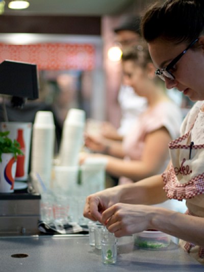a woman preparing food in a kitchen