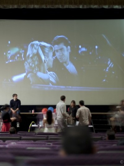 a group of people standing in front of a television
