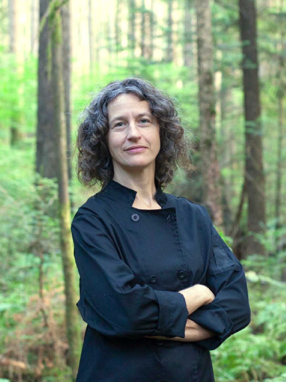 a person standing in a wooded area