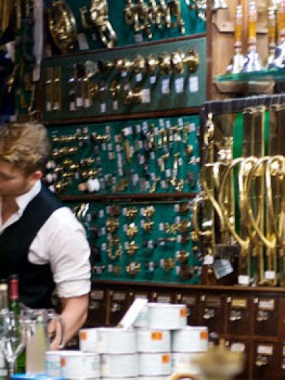 a man standing next to a bottle of wine