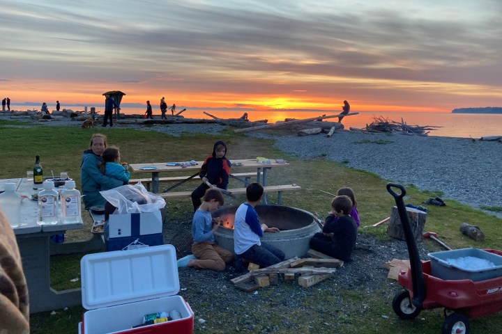 a group of people sitting at a beach