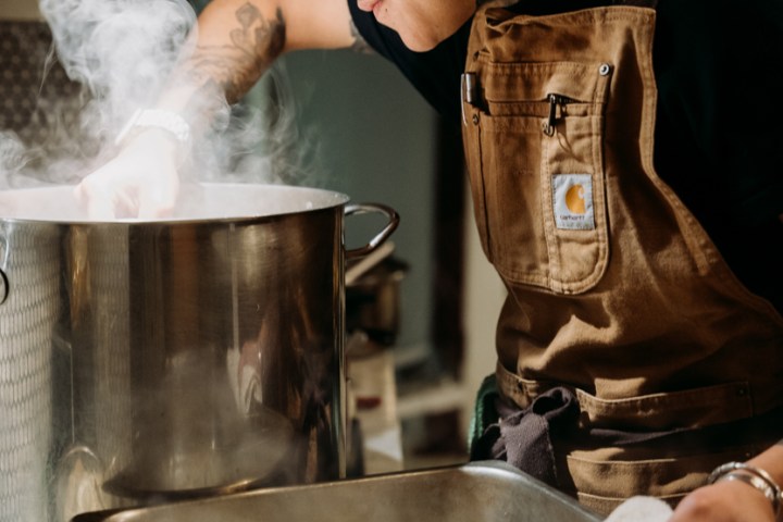 Chef Chelseah cooking food in a pot