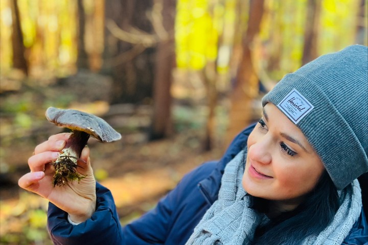 lady with mushroom in forest