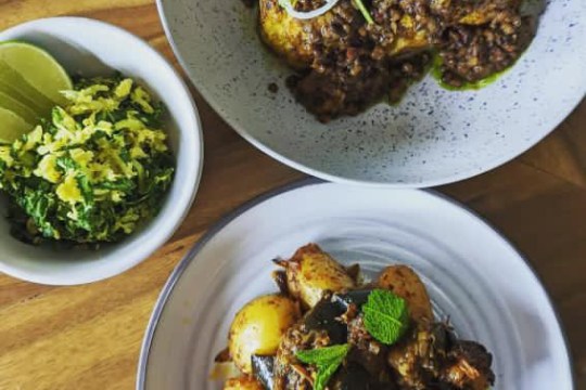 a bowl of food on a plate on a table